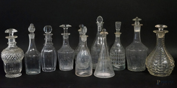 Lotto di undici ampolle in vetro e cristallo controtagliato, alt.max cm 25,5,  XX secolo, (difetti).
