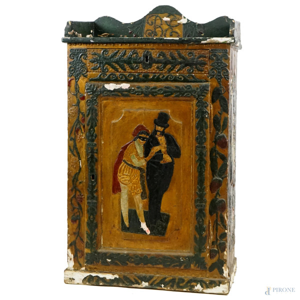 Mobiletto in legno laccato e dipinto, fronte ad un cassetto ed uno sportello, riserve raffiguranti scene di vita quotidiana, cm 103x59x37, XX secolo, (difetti).