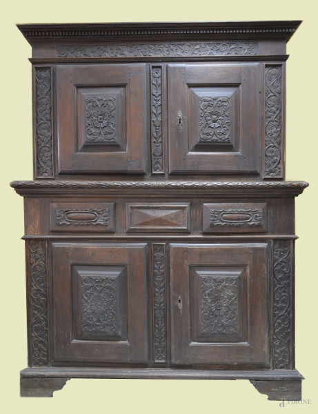 Credenza doppio corpo in noce a quattro sportelli e tre cassetti con particolari intagliati a decori di pampini d'uva, Italia centrale fine XIX sec, h.205x172x53 cm.