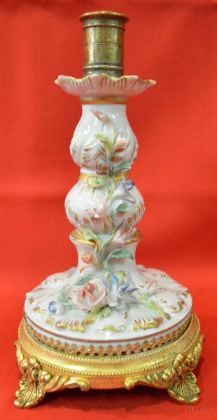 Candelabro in porcellana policroma con fiori a rilievo, poggiante su base in bronzo cesellato e dorato, h cm 24.