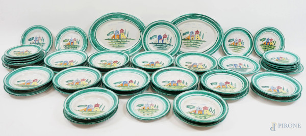 Servizio di piatti in ceramica smaltata, cavetto con decori policromi e tesa verde, XX secolo, misure max cm 39x28, (difetti).