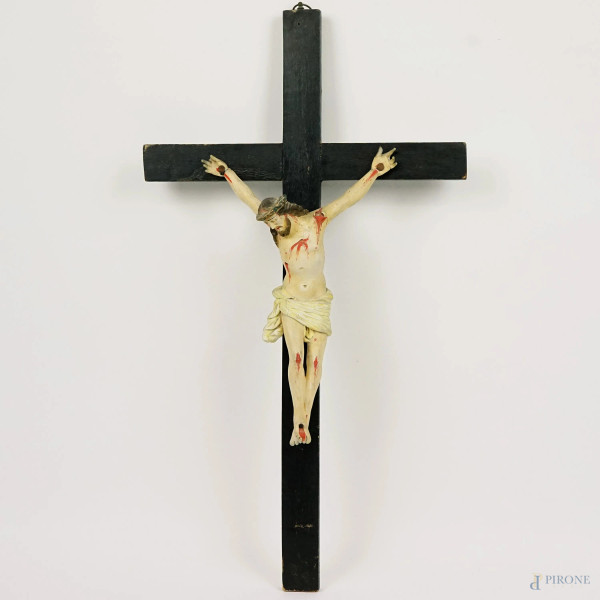 Crocifisso in gesso dipinto, con croce in legno ebanizzato, XX secolo, cm h 60x33x9, (difetti)