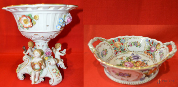 Lotto di un alzata centrotavola in porcellana policroma con fiori e putti musicanti a rilievo, marcato Capodimonte, h. 20 cm ed un cestino in maiolica policroma marcata, h. 6cm