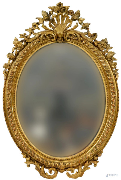 Specchiera di linea ovale in legno intagliato e dorato, Francia, XIX secolo,  ingombro cm h 123x84, (difetti).