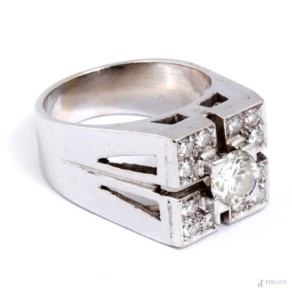 Anello in oro bianco con centrale brillante entro pavè di diamanti, peso lordo complessivo gr 10,8, misura 12