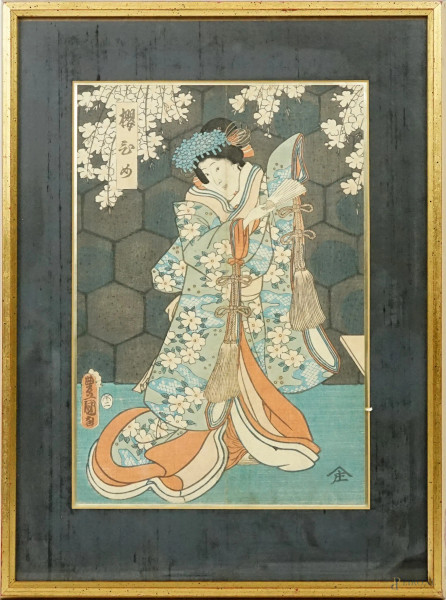 Donna con ventaglio sotto un ciliegio, stampa a colori recante iscrizioni, cm 34x23 circa, Giappone, XX secolo, entro cornice.