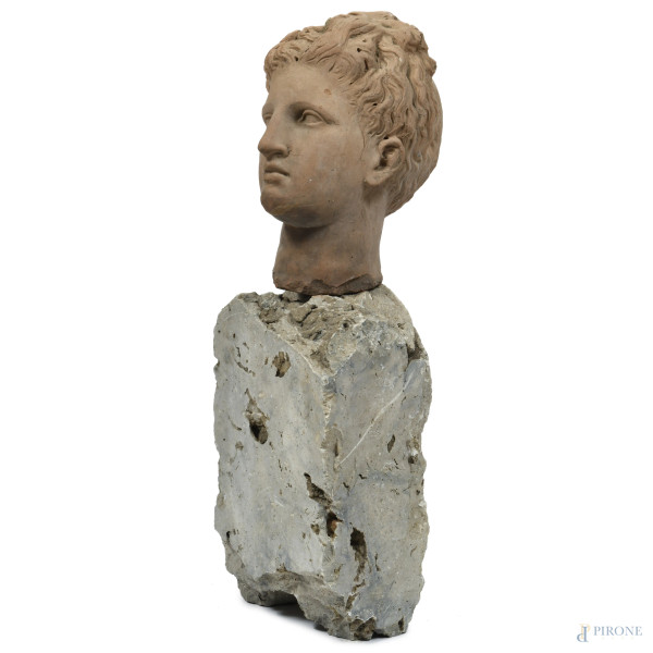 Testa virile in terracotta su base in pietra, XX secolo, altezza cm 82, (difetti, sbeccature, sca...