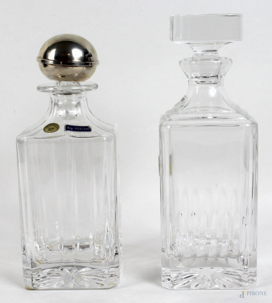 Due bottiglie in cristallo, altezza max cm. 25, una con tappo in argento, XX secolo.