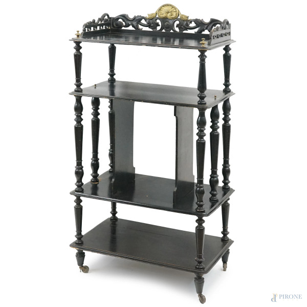 Piccola etagere in legno ebanizzato con particolari dorati, inizi XX secolo, a quattro ripiani, cm h 107x54x34.5,(difetti).