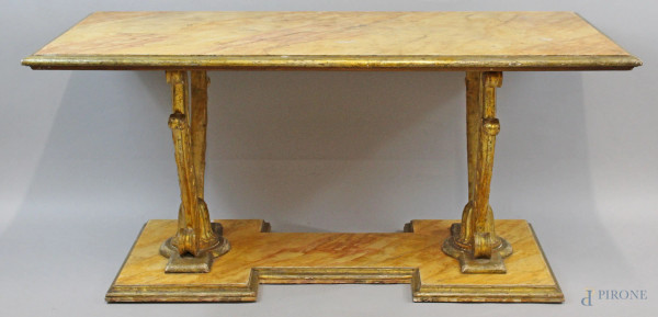Basso tavolo di linea rettangolare costruito con elementi antichi, piano e base dipinti e laccati a finto marmo, sorretti da coppia di fregi dorati, cm h 55x121x62, (segni del tempo).