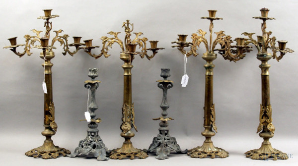 Lotto composto da tre coppie diverse di candelieri in metallo, h. max 48 cm, (difetti).