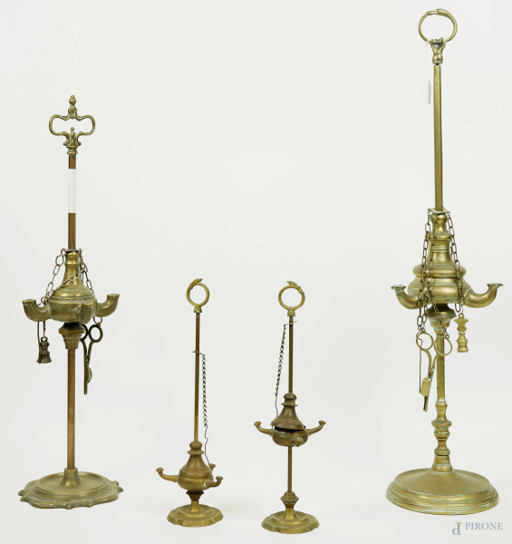 Quattro lucerne in bronzo e metallo dorato, alt. max cm 63,5.