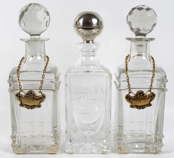 Tre bottiglie in cristallo, altezza max cm. 30, XX secolo.