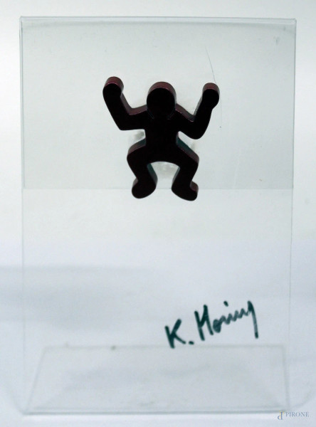Figura, multiplo in metallo dipinto in rosso poggiante su supporto in plexiglass, H 5,5 cm.