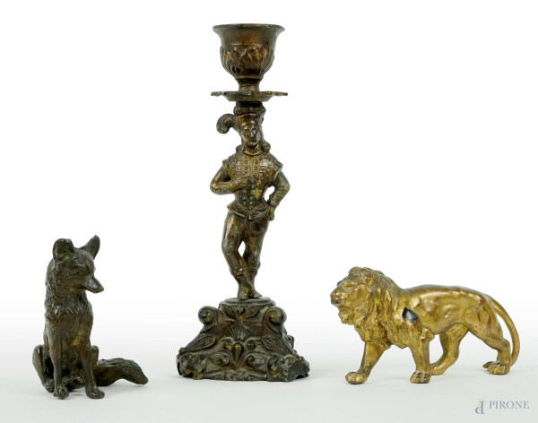 Lotto composto da due piccole sculture raffiguranti volpe e leone ed un candeliere con fusto a foggia di giullare, materiali diversi, alt. max cm 19,5, XX secolo, (segni del tempo).