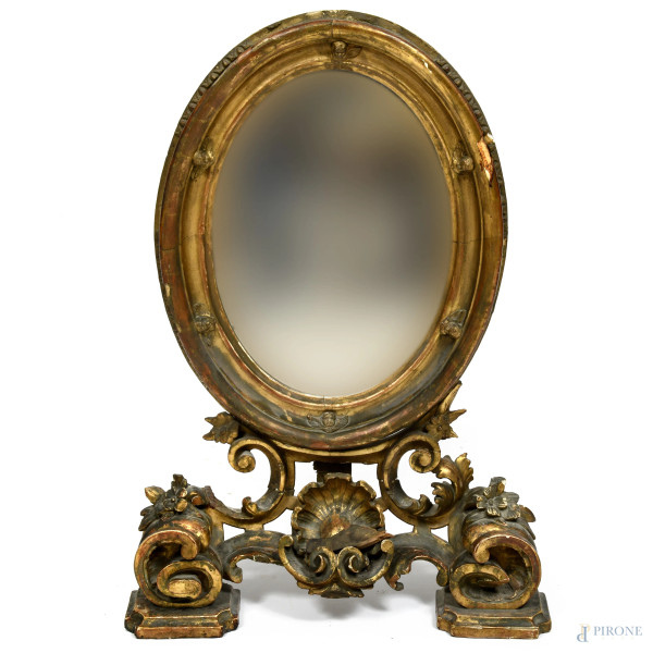 Specchio da toletta in legno dorato e intagliato a volute, XIX-XX secolo, cm 75x51x15, (segni di usura, difetti, graffi, scalfiture, cadute di doratura, fori di tarlo)
