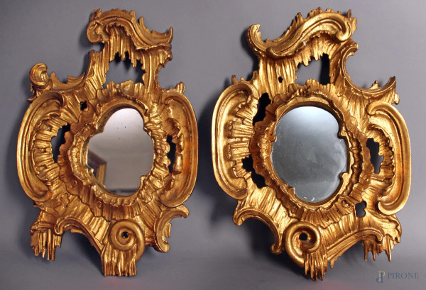 Coppia di specchierine in legno intagliato e dorato a motivi di foglie d&#39;acanto, XIX sec, h. 51x34 cm.