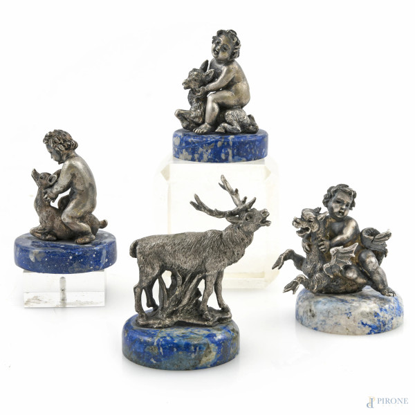Lotto di tre sculture in argento su base in lapislazzulo e una in argento su base in legno dipinto a finto lapislazzulo, XX secolo, altezza massima cm 6, peso complessivo lordo gr  346, ( lievi segni di usura)