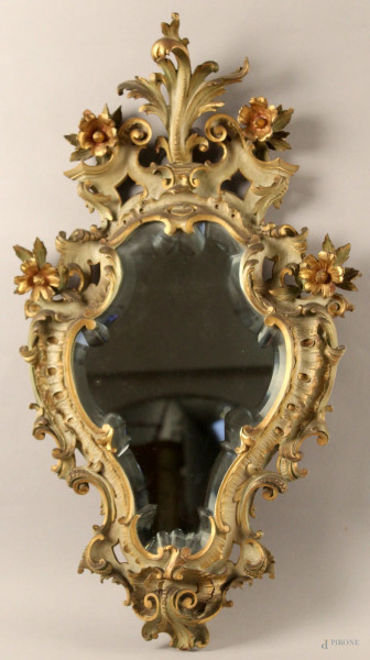 Specchiera di linea centinata in legno dipinto e dorato con intaglia a motivi di fiori e foglie d&#39;acanto, primi 900, h. 72 cm.
