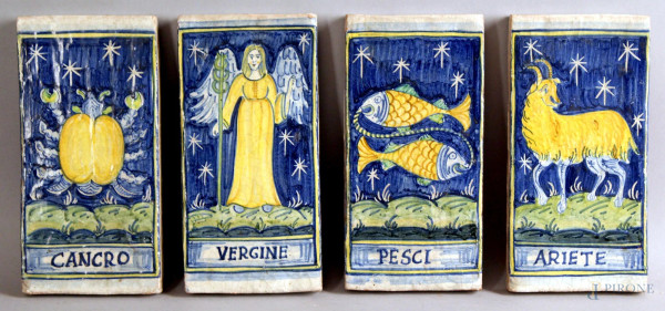 Lotto composto da quattro mattonelle in terracotta dipinta e smaltata, raffigurante segni zodiacali, cm. 20x10.