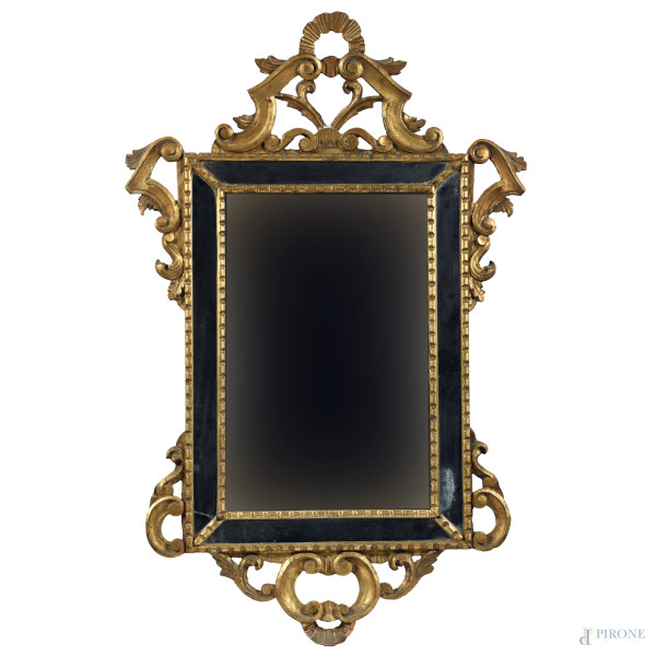 Specchiera in legno intagliato e dorato a volute, XX secolo, cm 88x56, (segni di usura, rotture, difetti)