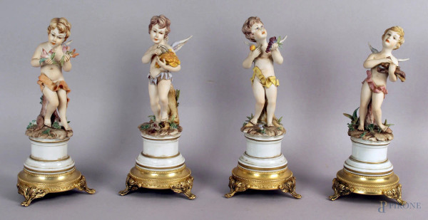 Lotto composto da quattro statuine in biscuit, raffiguranti allegorie delle stagioni, base in metallo dorato, altezza 19 cm, (difetti).
