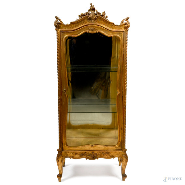 Mobile vetrina in legno intagliato e dorato con fronte sormontato da elementi intagliati a volute, poggiante su gambe arcuate inagliate a volute, XX secolo, cm 183x69,5x40, (difetti)