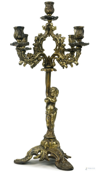 Candelabro in bronzo dorato a cinque fiamme, fusto sostenuto da putto poggiante su base a tripode, cm h 49, XIX secolo, (segni del tempo).