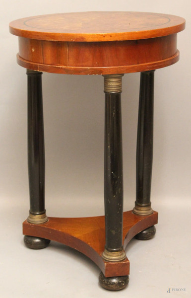 Tavolinetto di linea impero, in radica di noce, ad un cassetto, poggiante su tre colonne ebanizzate, finiture in bronzo, H. 74 cm., diametro 50 cm.